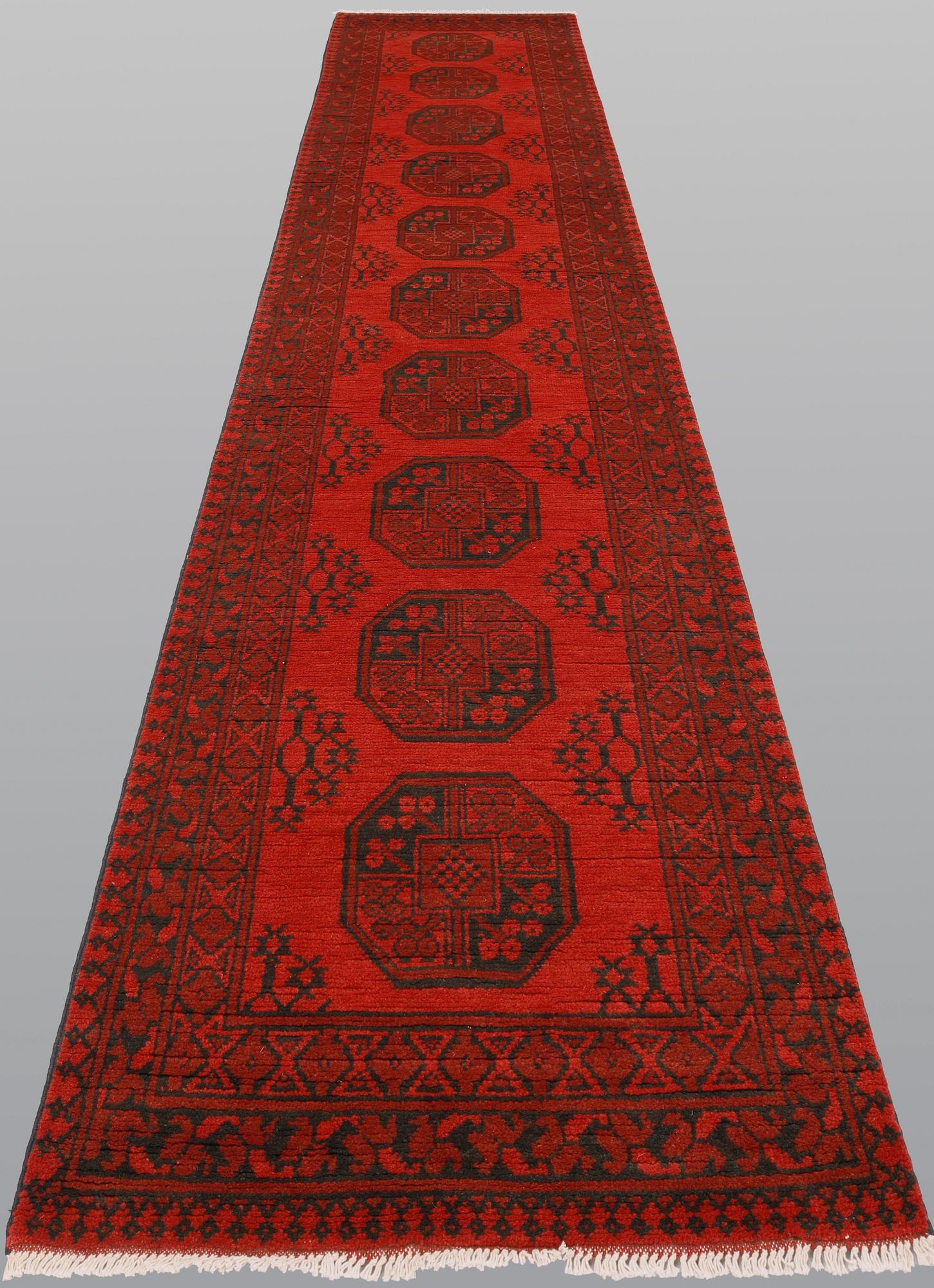 An Afghan runner, ca 390 x 79 cm.