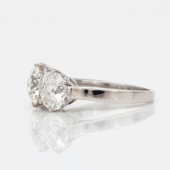 A three stone old mine and old cushion cut diamond ring. Total carat weight 4.01cts.