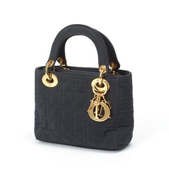 562. A black quilt silk evening bag by Christian Dior.