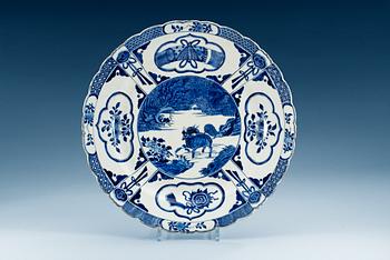 1697. A blue and  white charger decorated with a Qilin and phoenix, Qing dynasty, Kangxi (1662-1722).