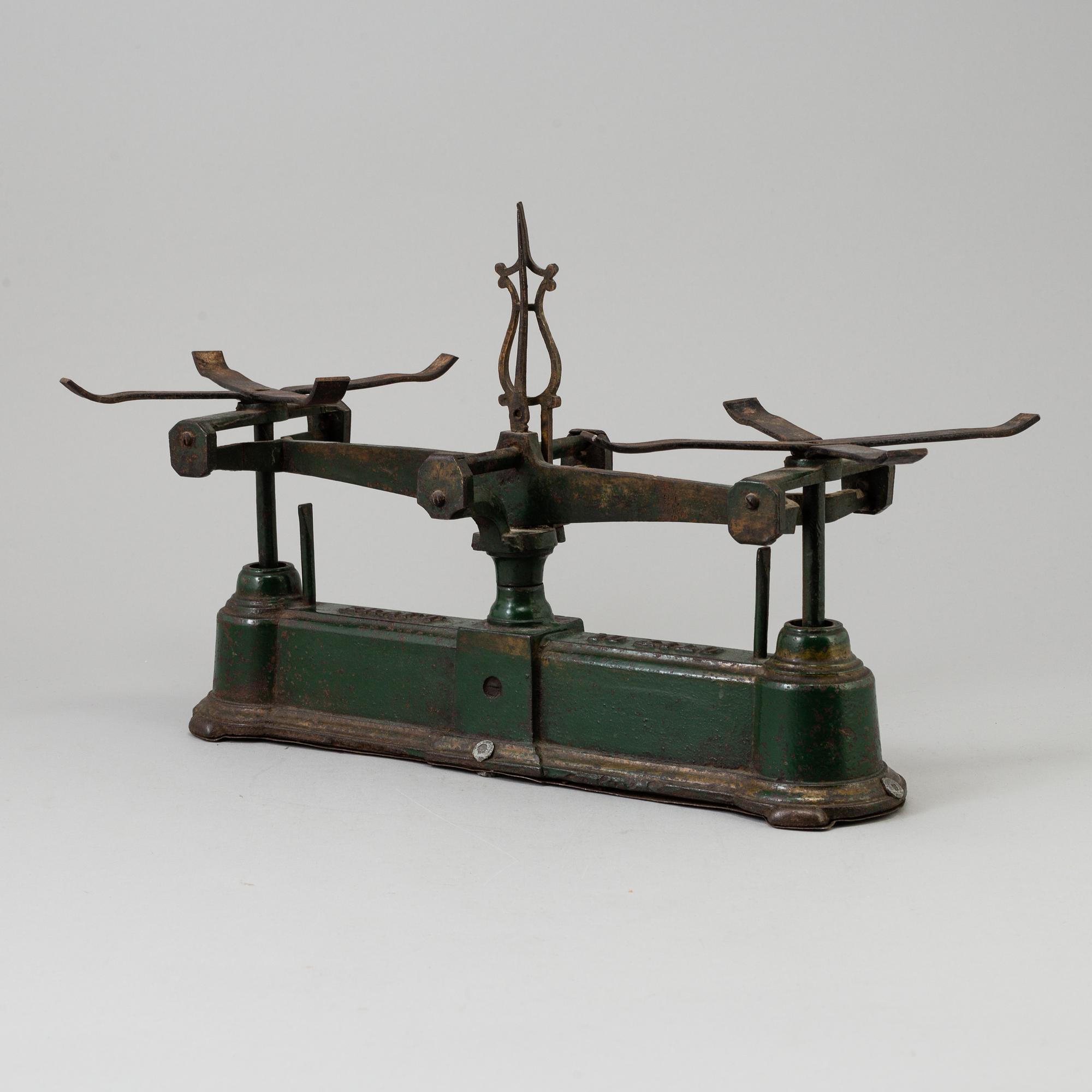 A 20th century cast iron balance with brass and iron weights, partly Skultuna, Sweden.