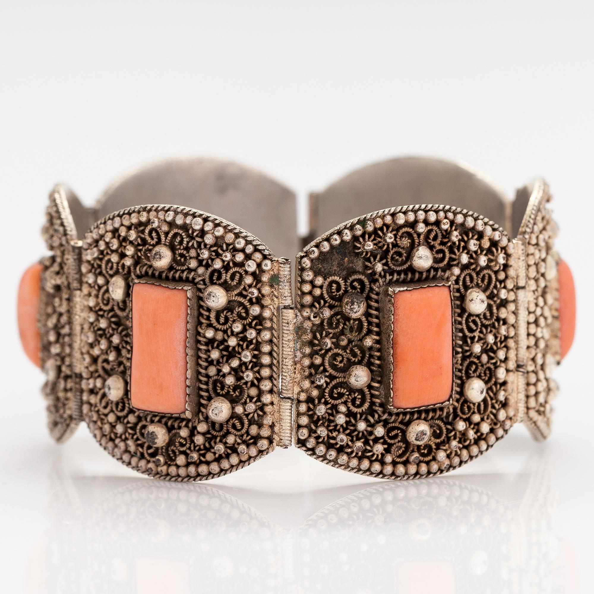 A silver bracelet with corals.