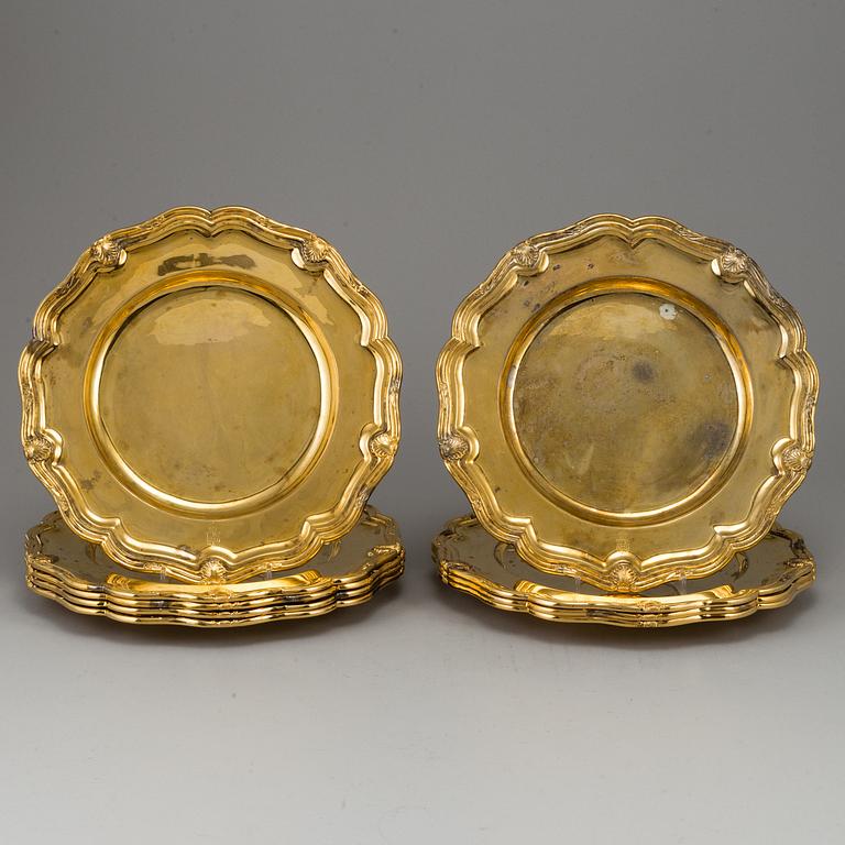 A German set of twelve 19th century silver-gilt plates, mark of Hossauer, Berlin. Rokoko-style.