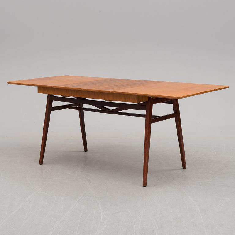 A teak veneered dining table, 1950's/60's.