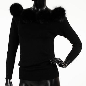 YVES SAINT LAURENT, a black wool sweater with fox pompons.