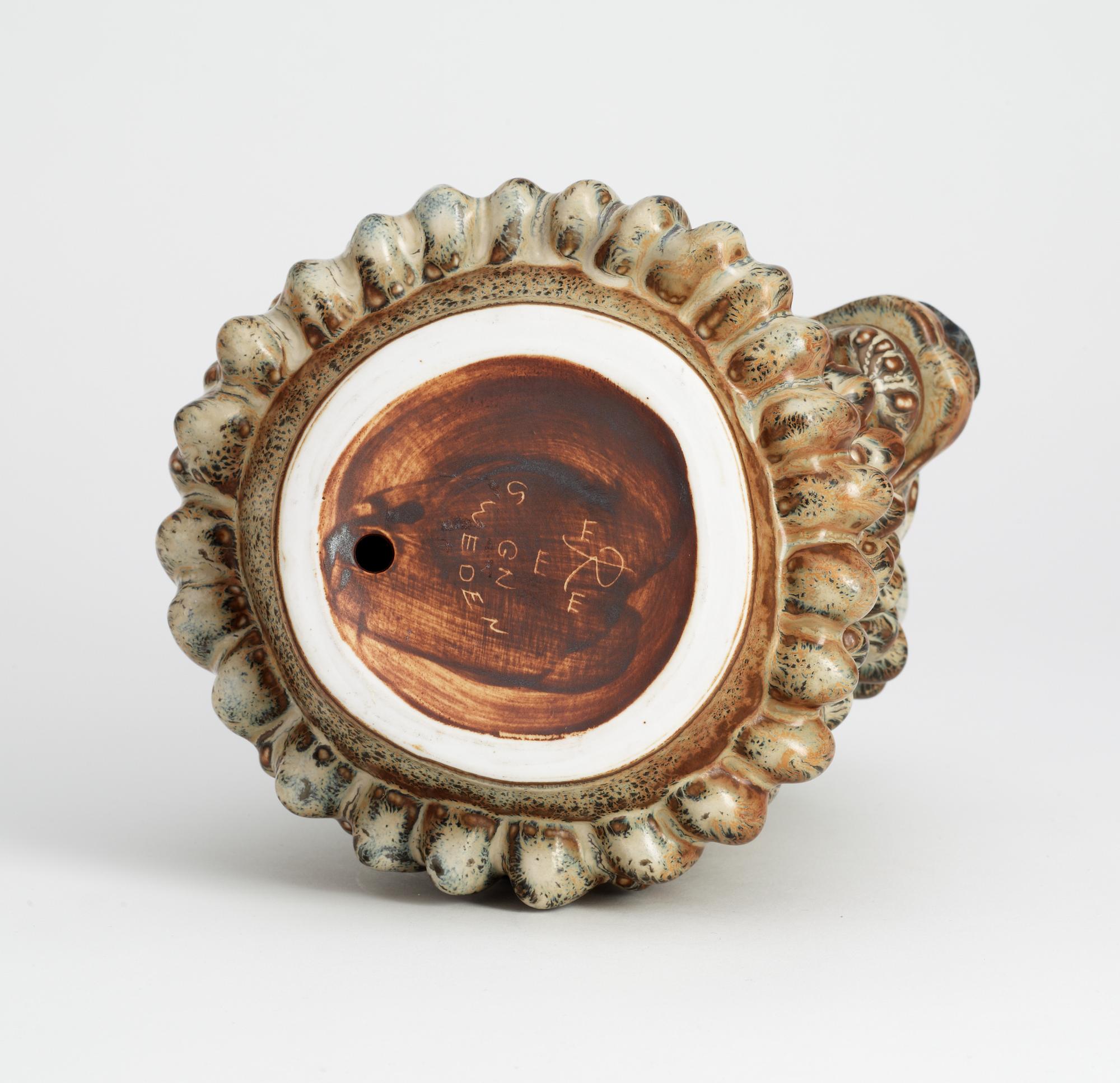 A Gunnar Nylund stoneware figure of a lion's head, Rörstrand.