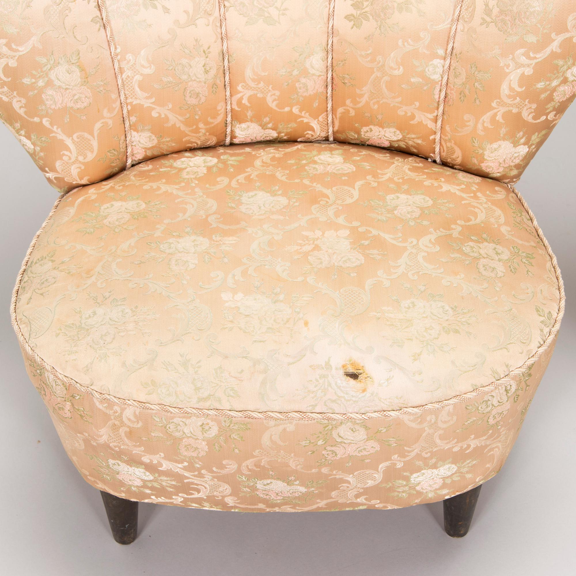 A pair of mid-20th century armchairs.