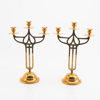 A öair of brass candelabras 20th century.