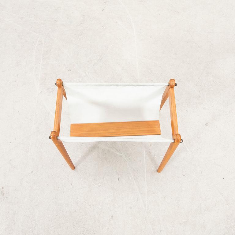 A 1960s teak newspaper holder.