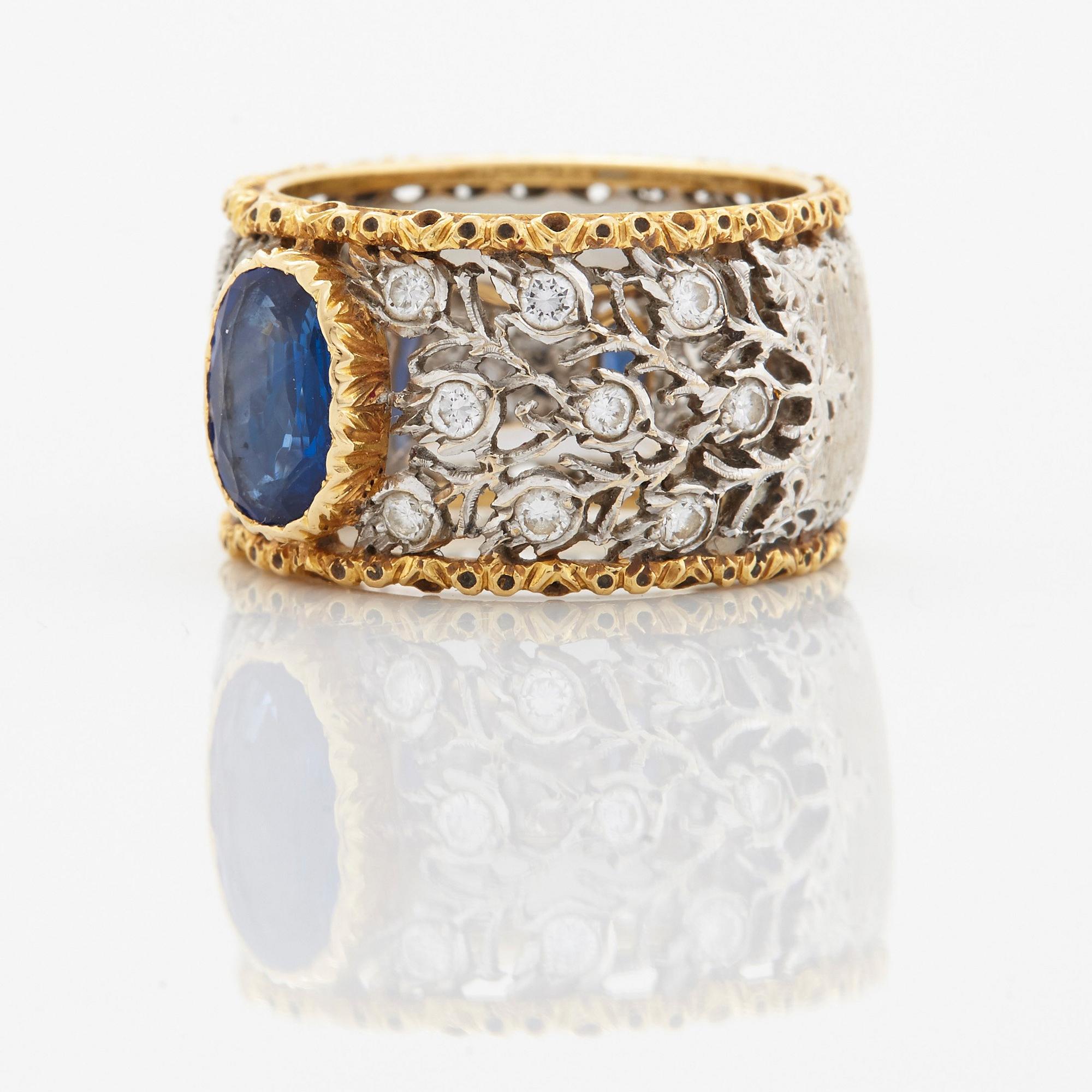 A Buccellati ring in 18K gold and white gold set with a faceted sapphire and round brilliant-cut diamonds.