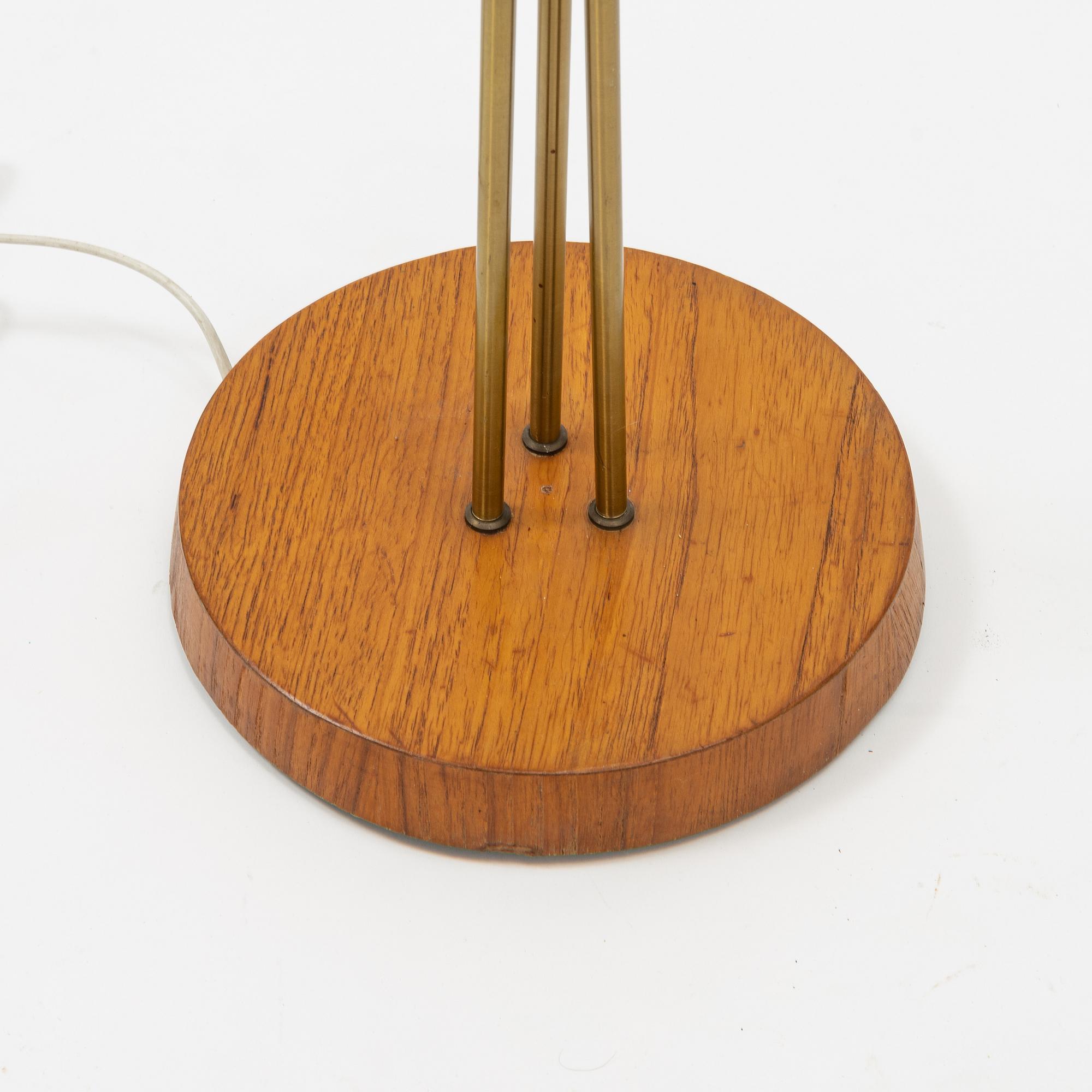 A brass and teak floor light, 1950's.