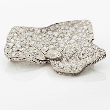 A brooch in platinum set with round brilliant-cut and eight-cut diamonds.