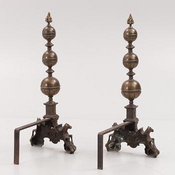 A pair of brass andirons, first half of the 20th century.