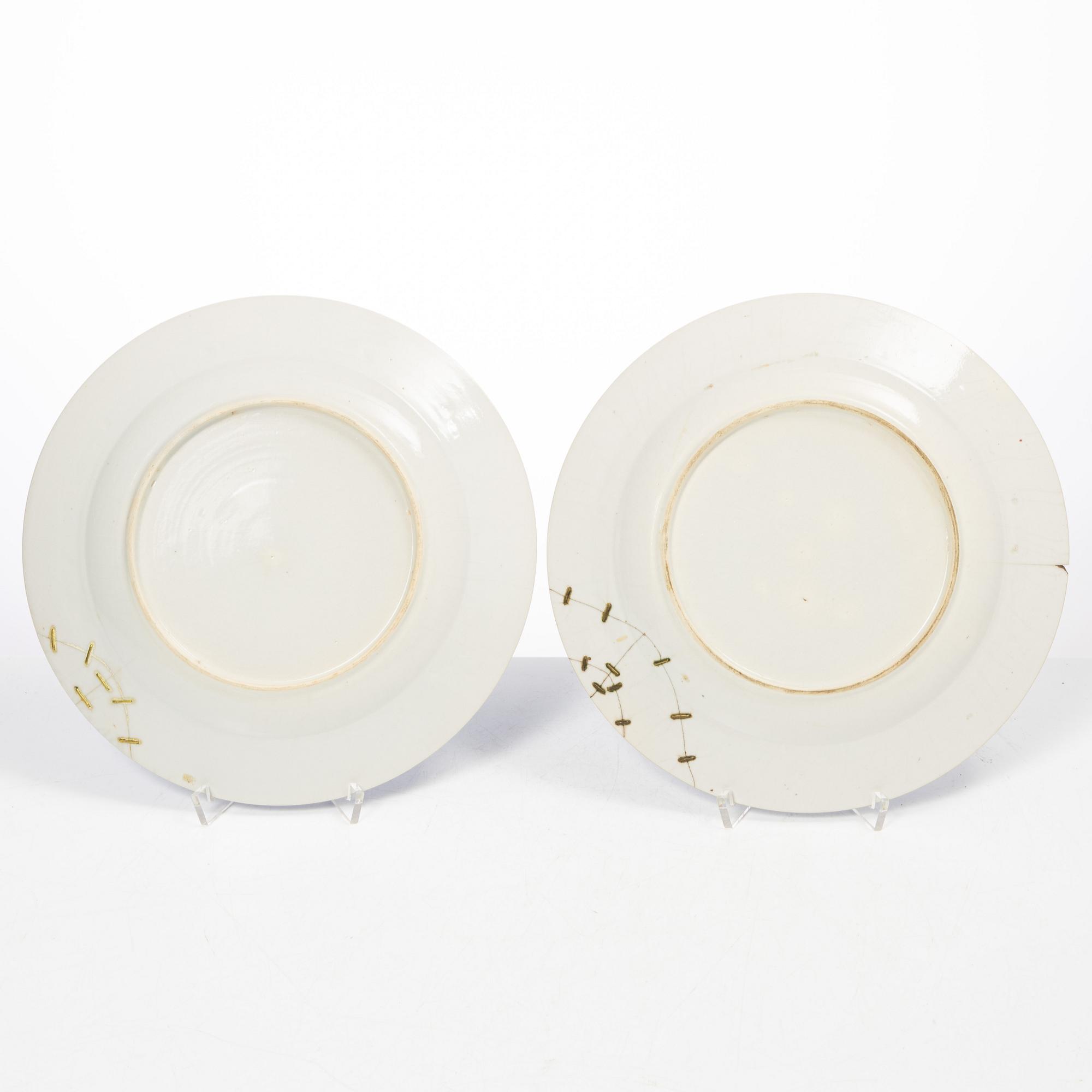 A pair of armorial dinner plates, soft paste, Qing dynasty, 18th century.