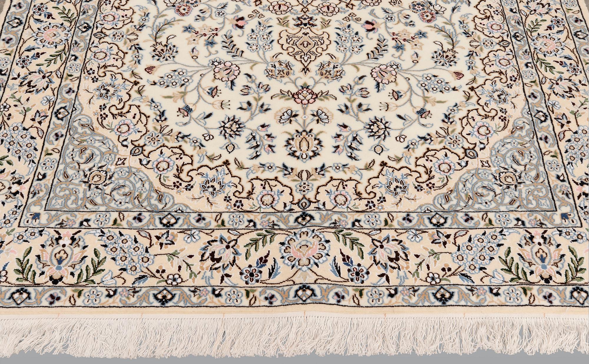 A Nain part silk carpet, 254 x 156 cm.