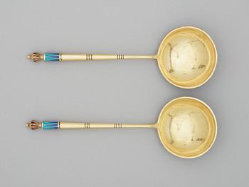 A pair of Russian 20th century silver-gilt and enamel kaviar spoons, makers mark of A. Lubavin, St. Petersburg 1908-17.