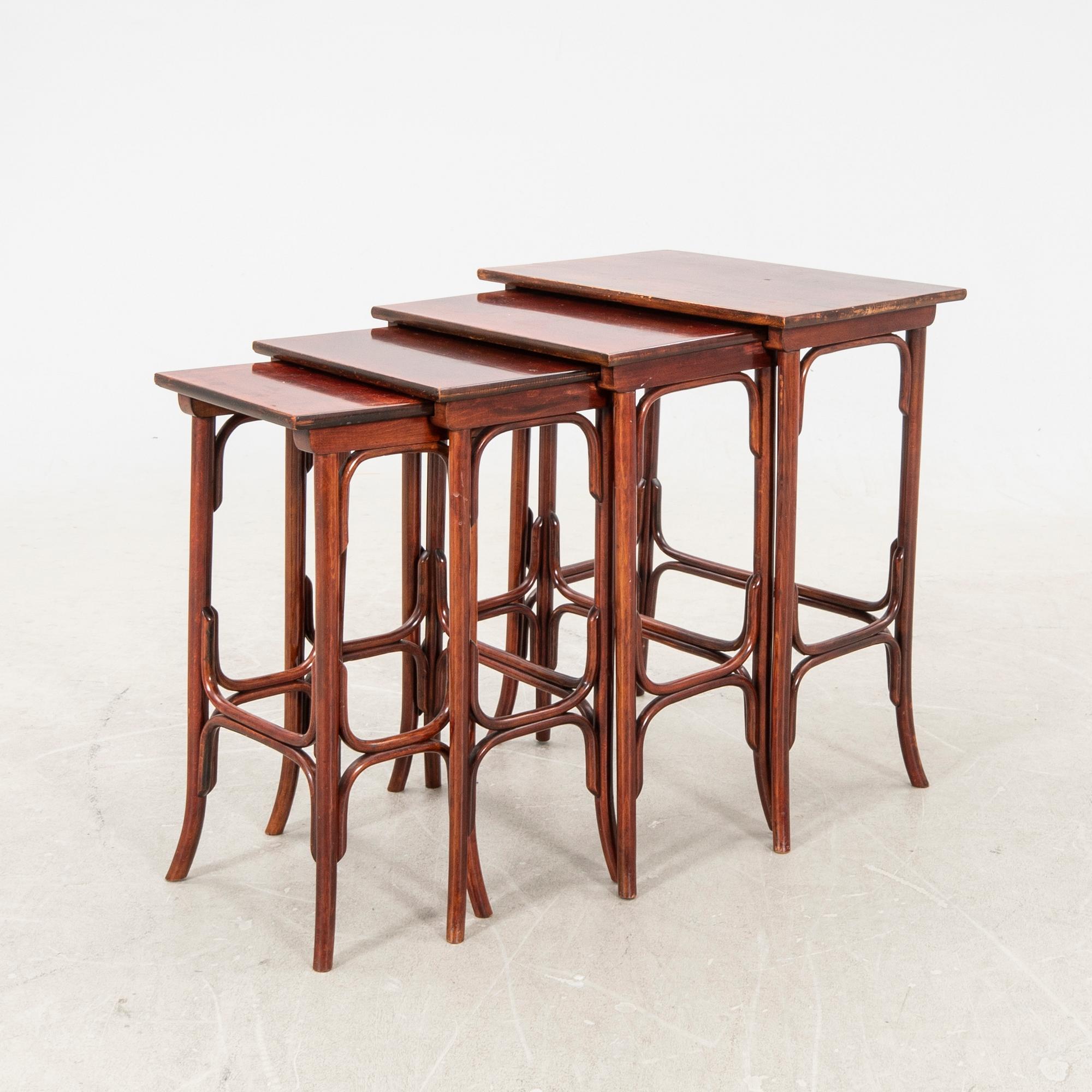 An early 19th century nest of four tables in stained beech from Thonet.
