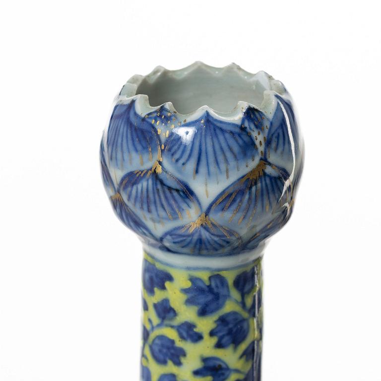 A Chinese blue and white 'clobbered' porcelain tulip vase, Qing dynasty, 19th century.