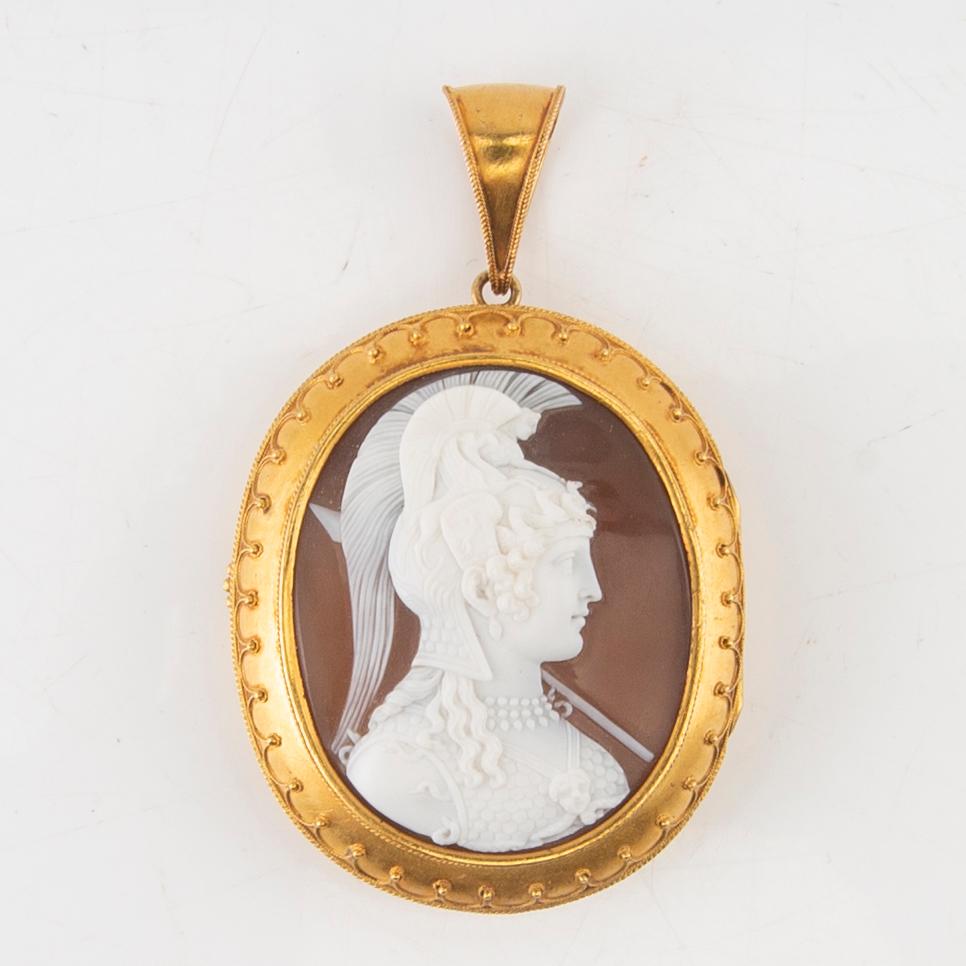 A 14K gold medallion with carved shell cameo.