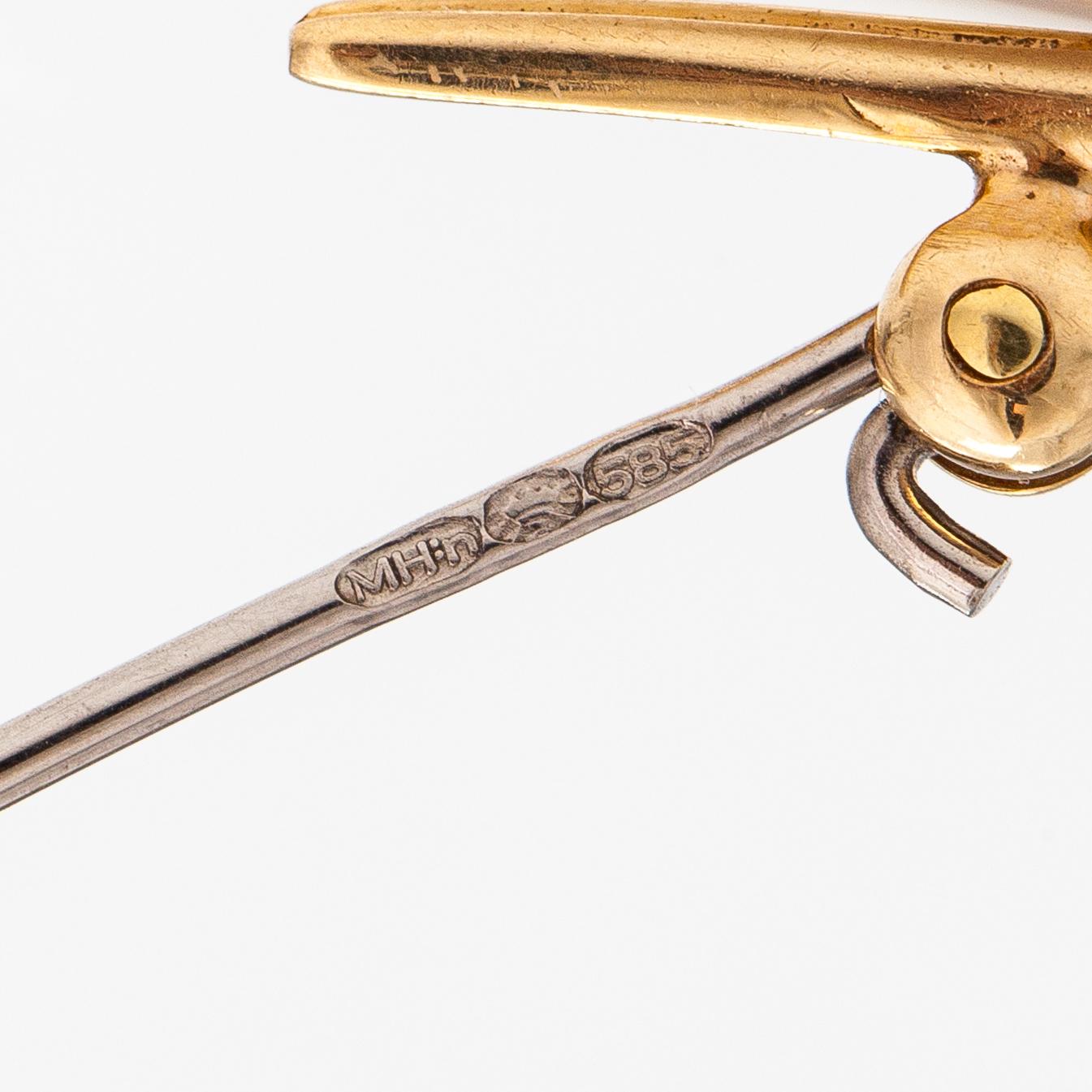 A 14K gold brooch with an aquamarine and a diamond ca. 0.02 ct.