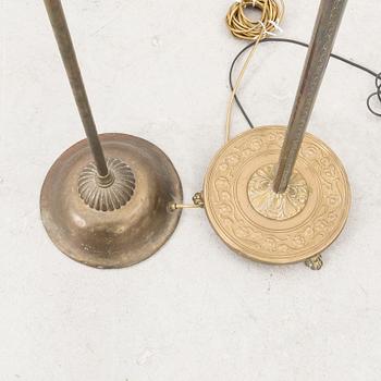A set of two brass floor lamps later part of the 20th century.