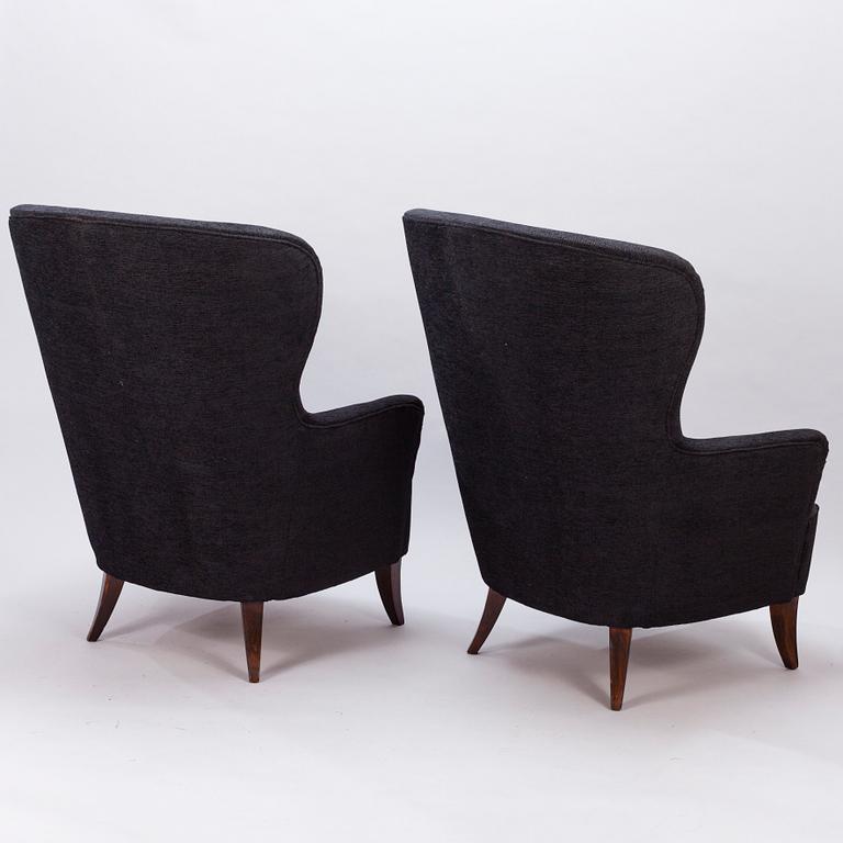 A pair of mid-20th century armchairs.