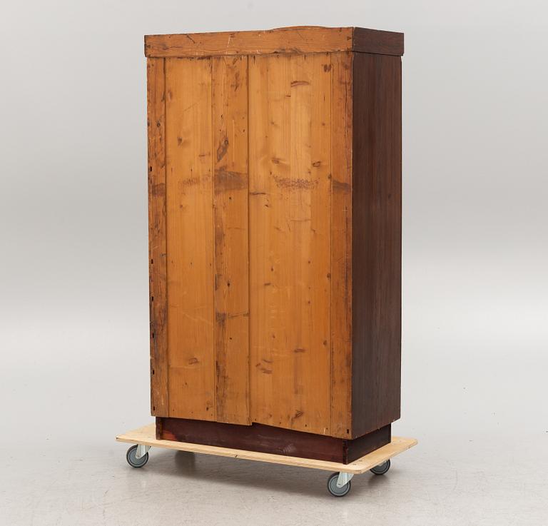 An early 20th century oak cabinet with drawers.