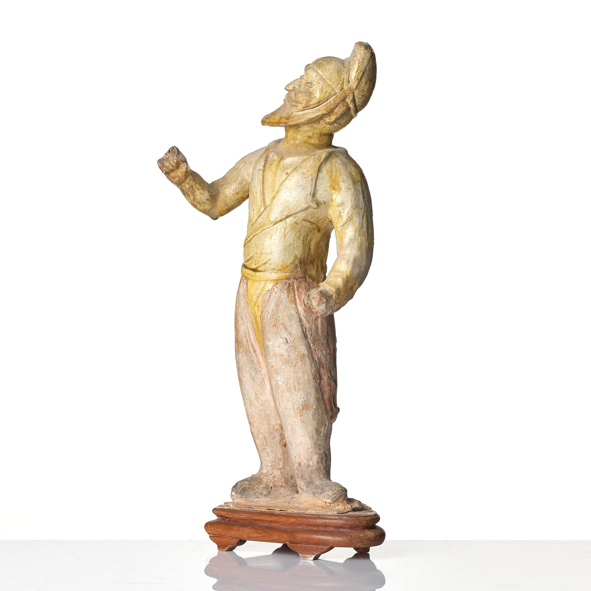 A yellow glazed potted figure of a groom, Tang dynasty (618-907).
