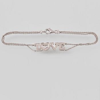 ARMBAND, 18K vitguld med briljant och baguettslipade diamanter ca 0.19 ct. Vikt 2,9 gram.