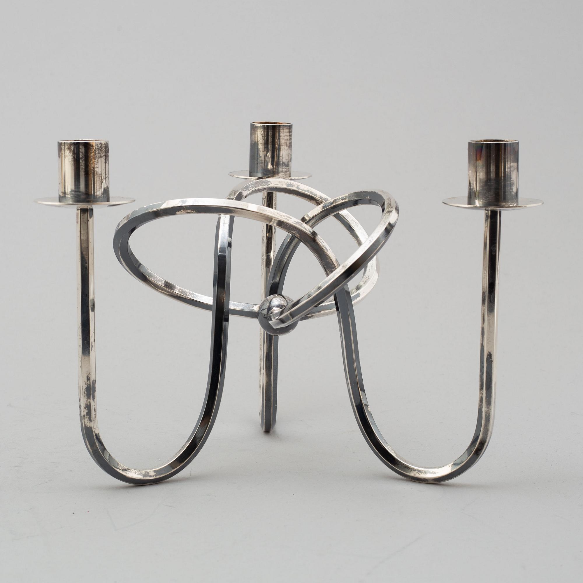 JOSEF FRANK, kandellaber, "Vänskapsknuten", försilvrad mässing. 2000-tal.