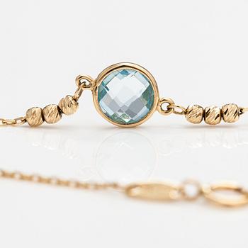 A 14K gold bracelet with a topaz. Kultajousi, Helsinki.