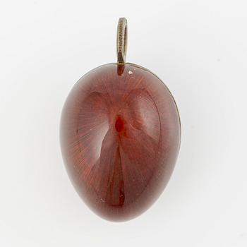 Pendant in the shape of an egg, silver with red enamel.
