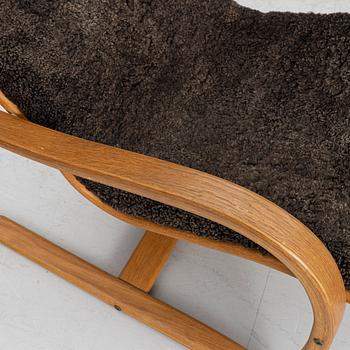 Jan Ekström, a "Gazell" armchair with a footstool, 21st century.