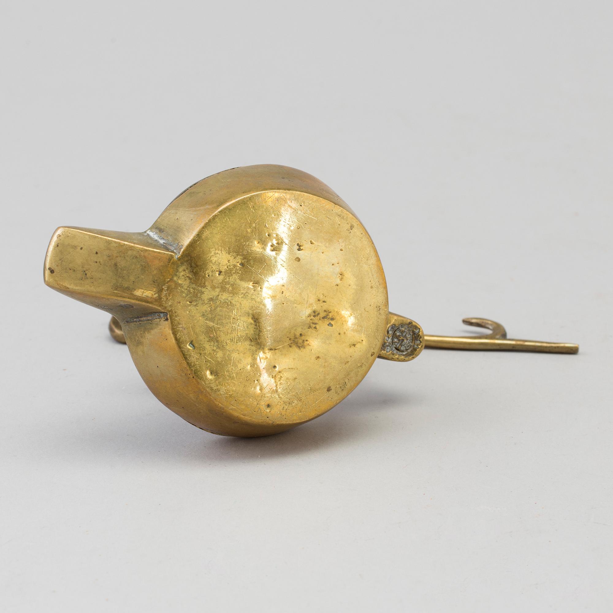 An 18th century bronze oil lamp.