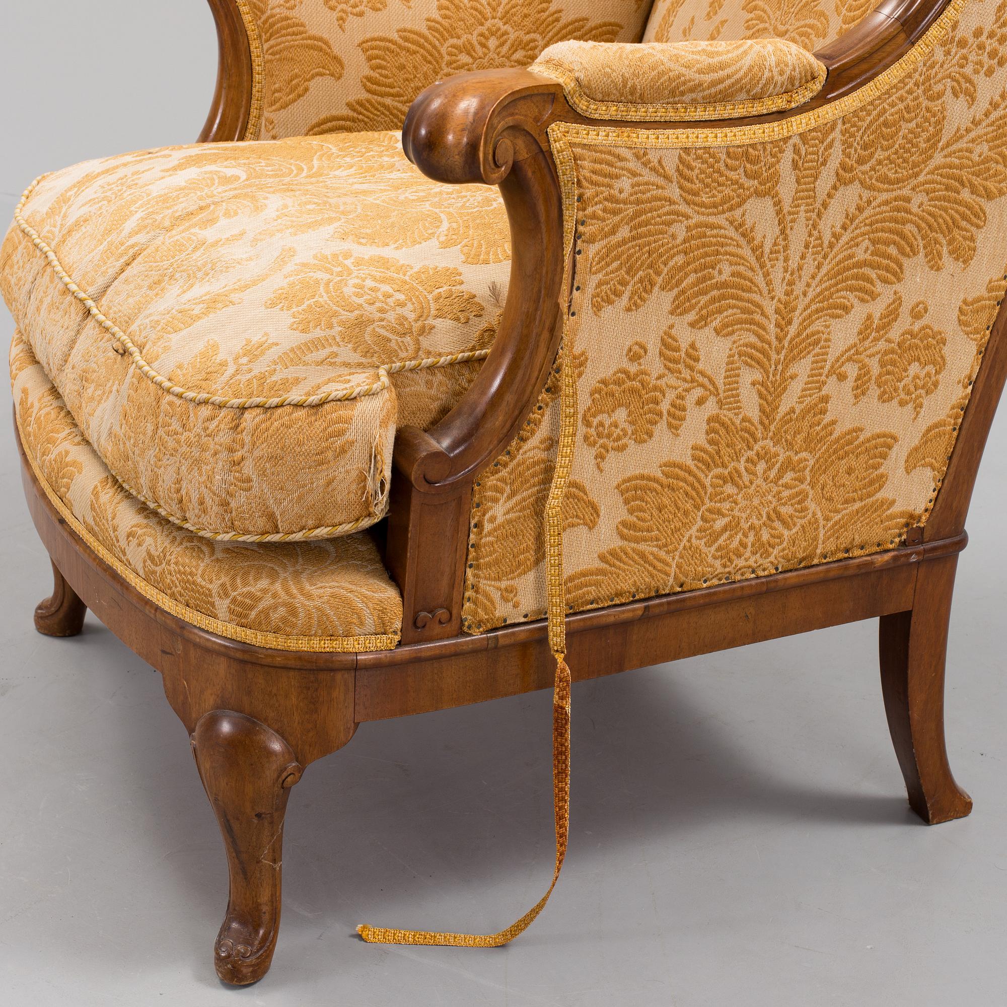 A Rococo style wing chair, first half of teh 20th Century.