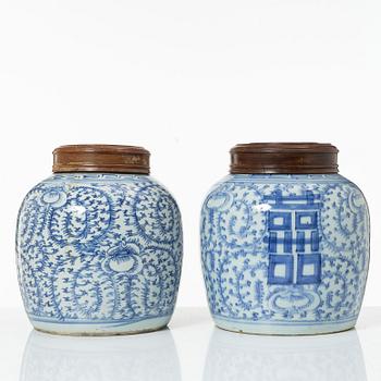 Two similar Chinese blue and white porcealin jars with wooden covers, Qing dynasty, 19th Century.