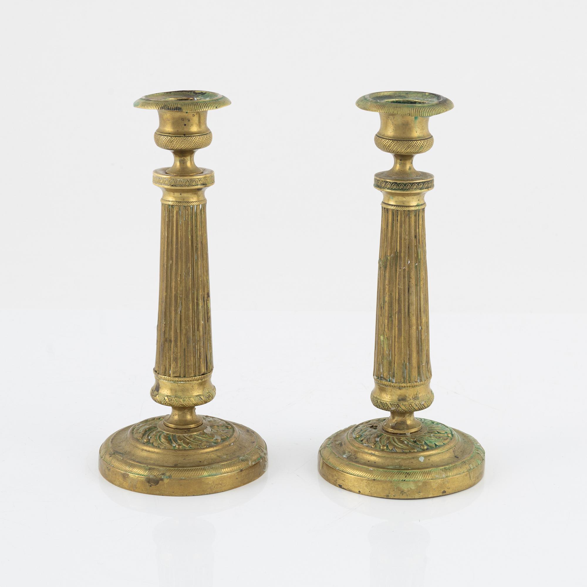 A pair of Empire bronze candlesticks, first half of the 19th Century.