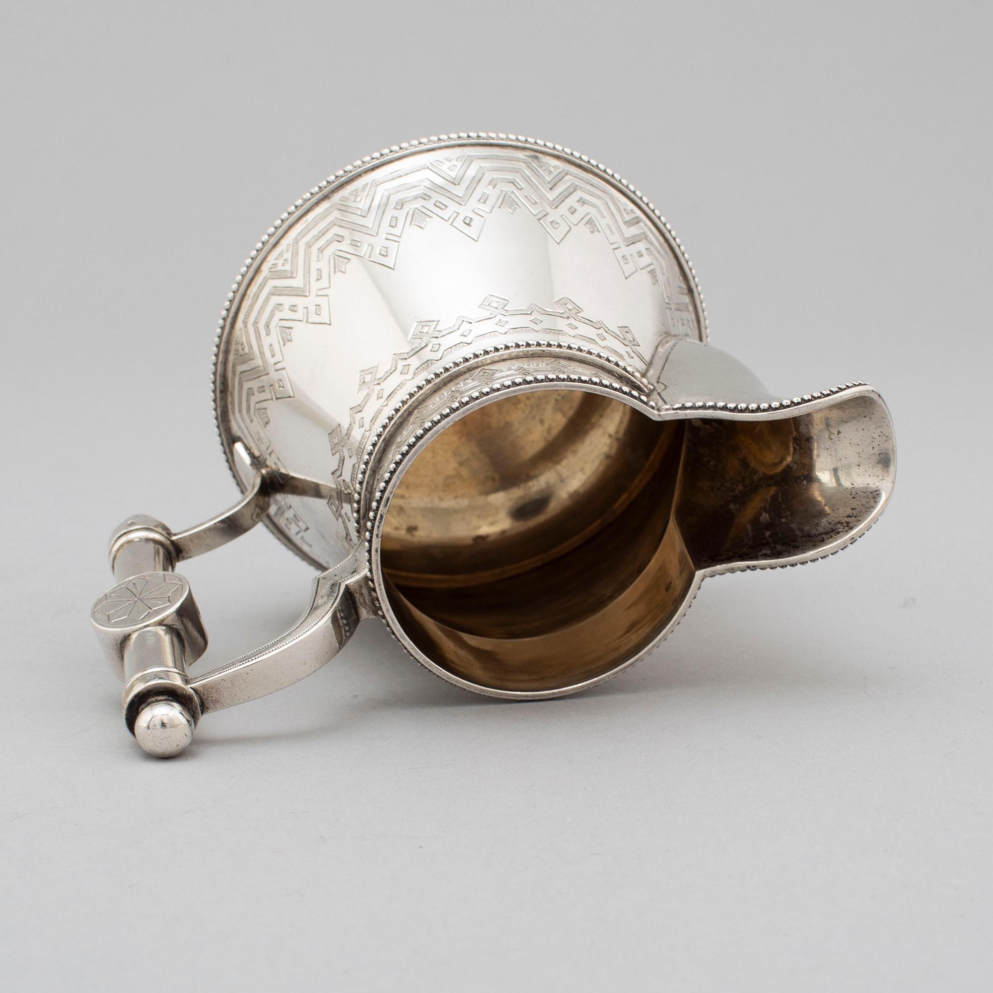 A Russian 19th century parcel-gilt silver tea pot and cream jug, mark possbly of Alexander Lokin, St. Petersburg 1893.