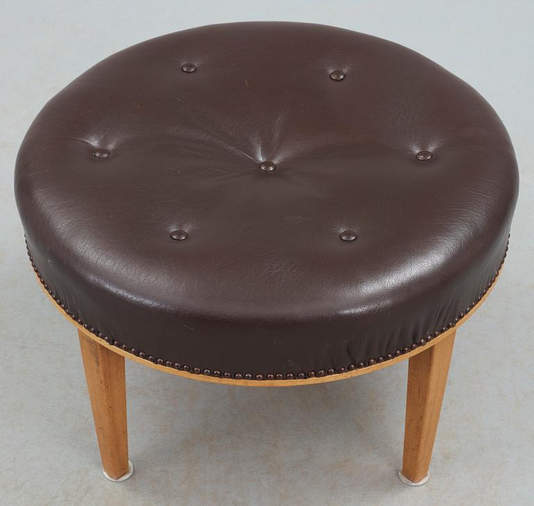 A Josef Frank mahogany and brown leather stool by Svenskt Tenn.