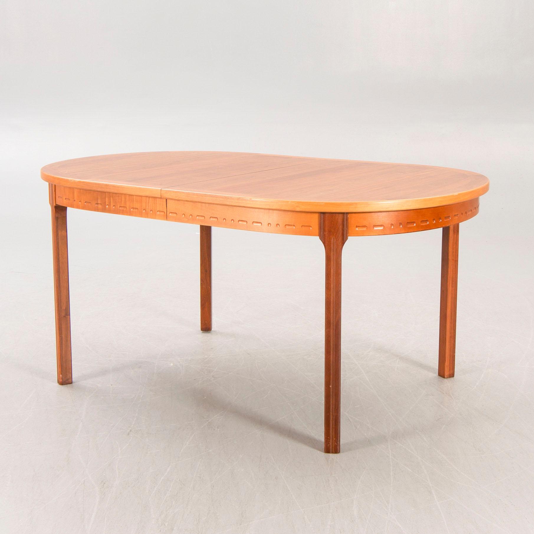 A Nils Jonsson teak and walnut 1960s dining table.