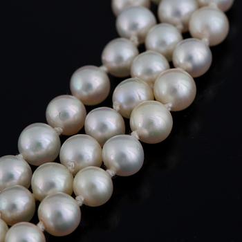 Three strand cultured pearl necklace, clasp with diamonds.