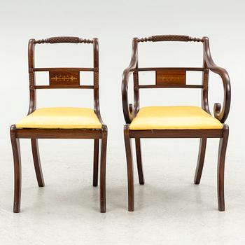 An Empire style dining table and ten chairs, second half of the 20th Century.