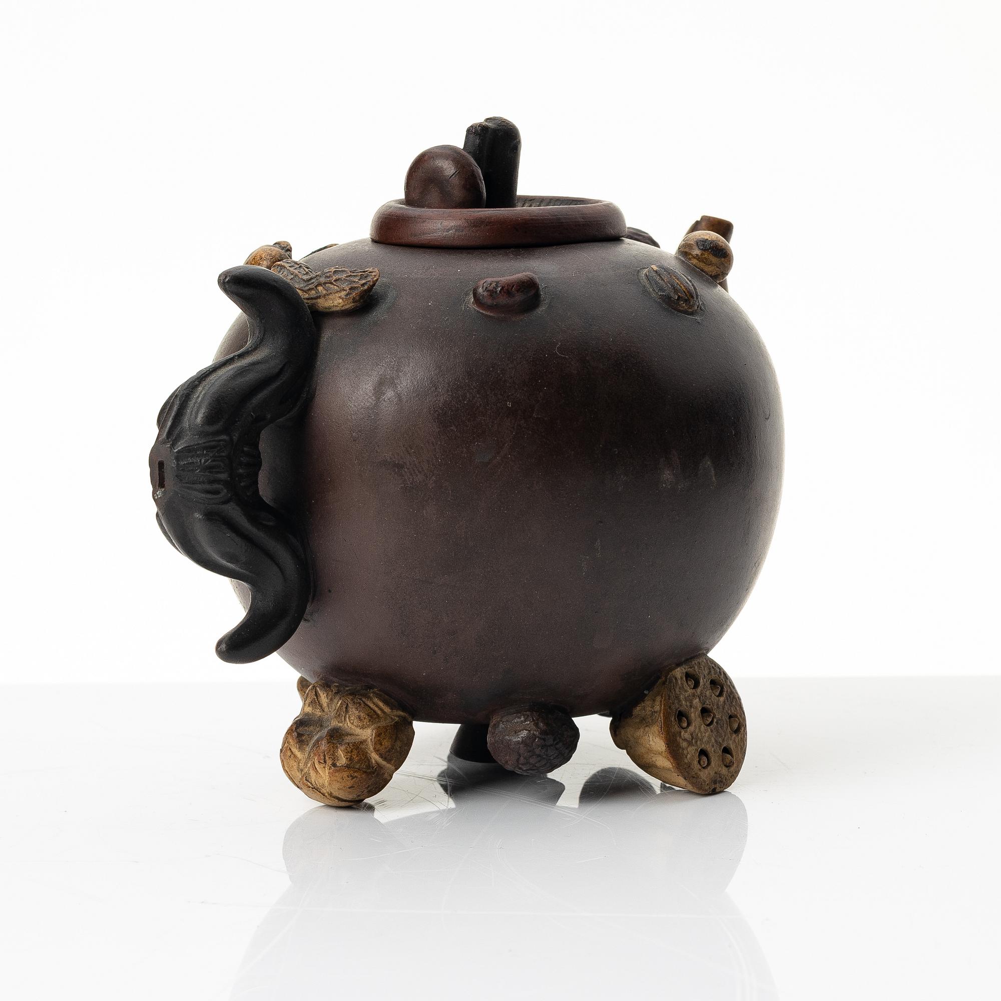 A Chinese 'hundred-fruit' yixing teapot, Qing dynasty (1644-1912).