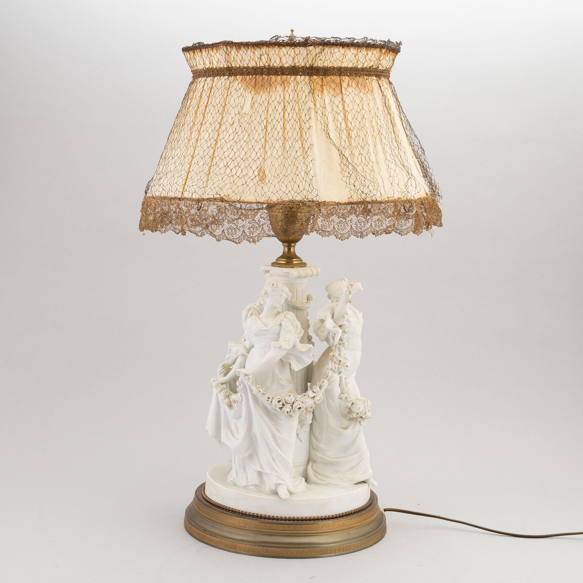 A parian and metall table lamp, first half of the 20th century.