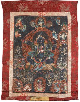 395. A Tibetan Thangka of Mahakala surrounded by fierce Dharma protectors, 19th century.