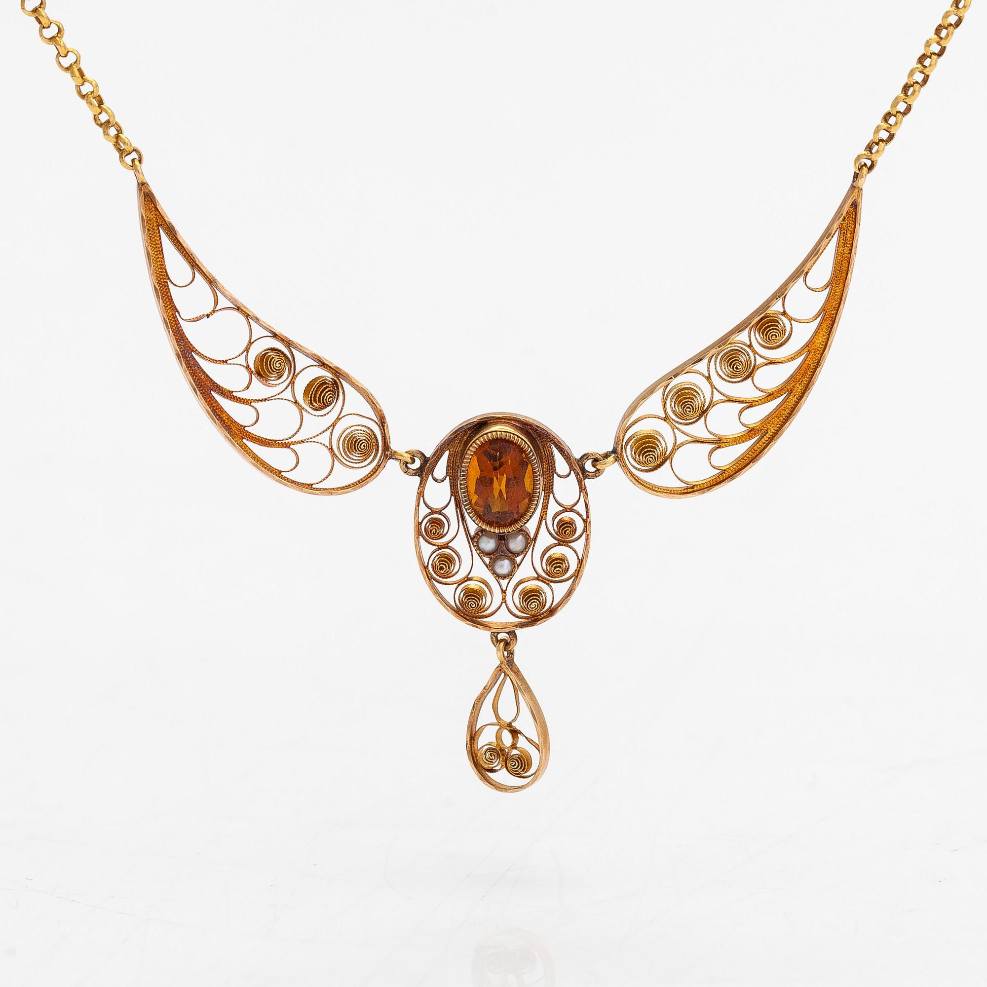 An 18K gold filigree necklace with seed pearls and a citrine, Stockholm 1910.
