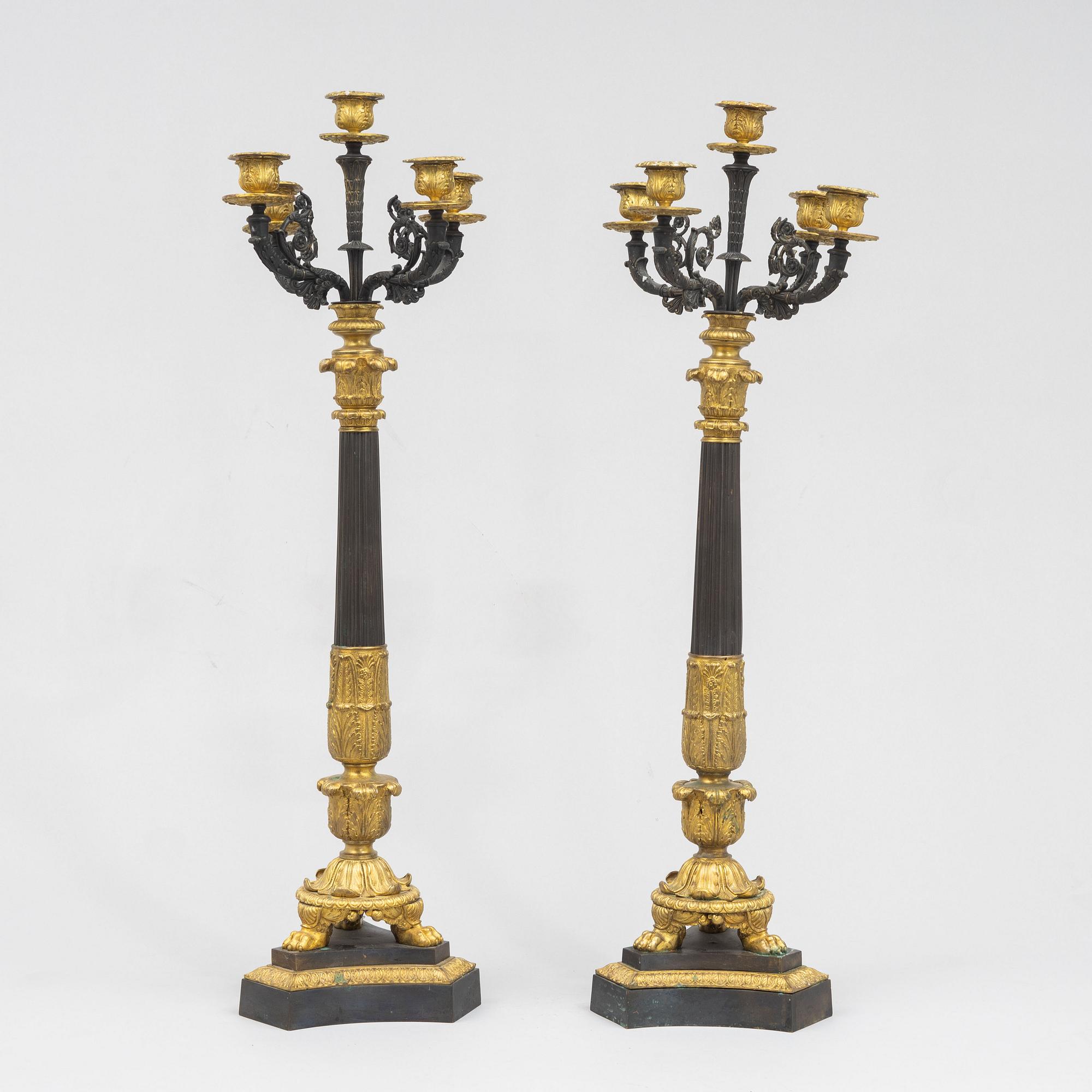 A pair of French Empire-style patinated and gilt bronze five-light candelabra, later part 19th century.
