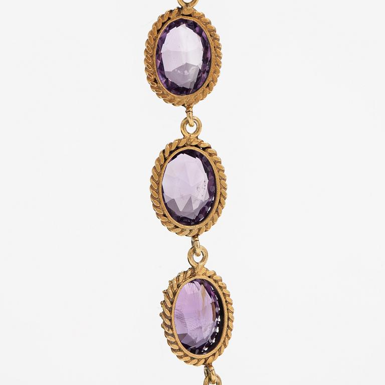 A necklace, bracelet and two brooches in gilded silver and with amethysts and pearls.