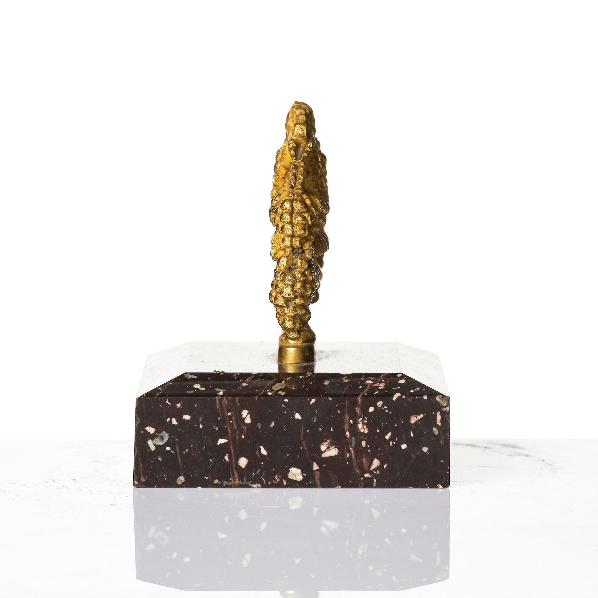 An Empire 'Loka-Risberg'-porhyry and ormolu paperweight, Älvdalen, early 19th century.