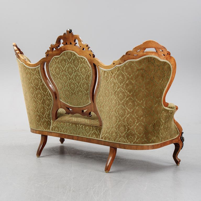 A rococo style sofa, four chairs and a table, second half of the 19th Century.